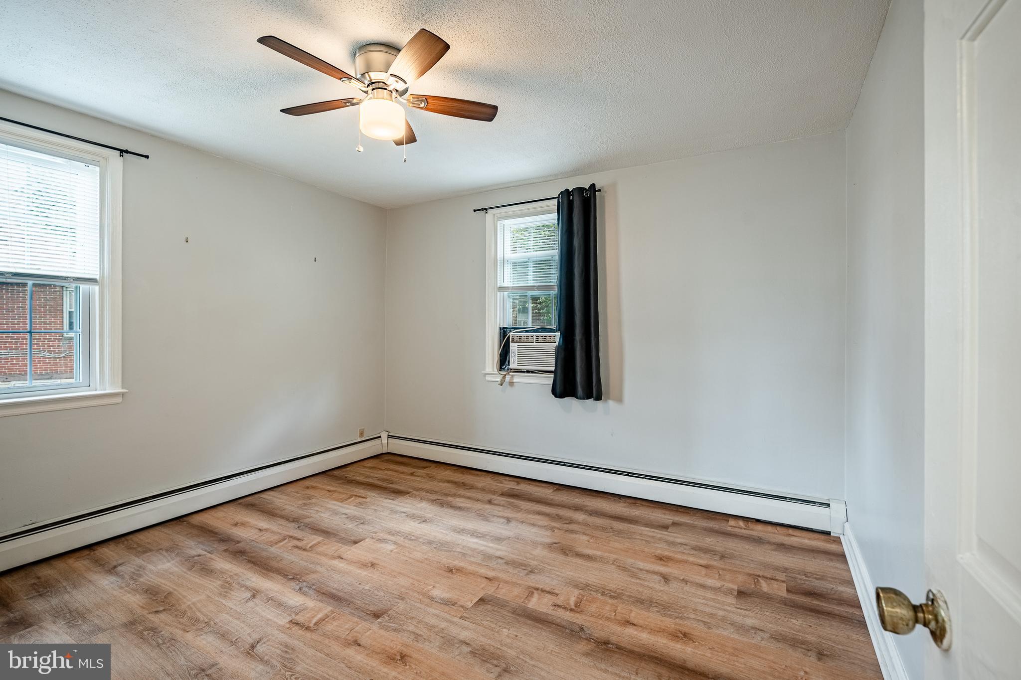 4234 Valley Road, Unit 1 Drexel Hill, PA 19026 - Photo 12 of 19 a view of an empty room with window and a ceiling fan