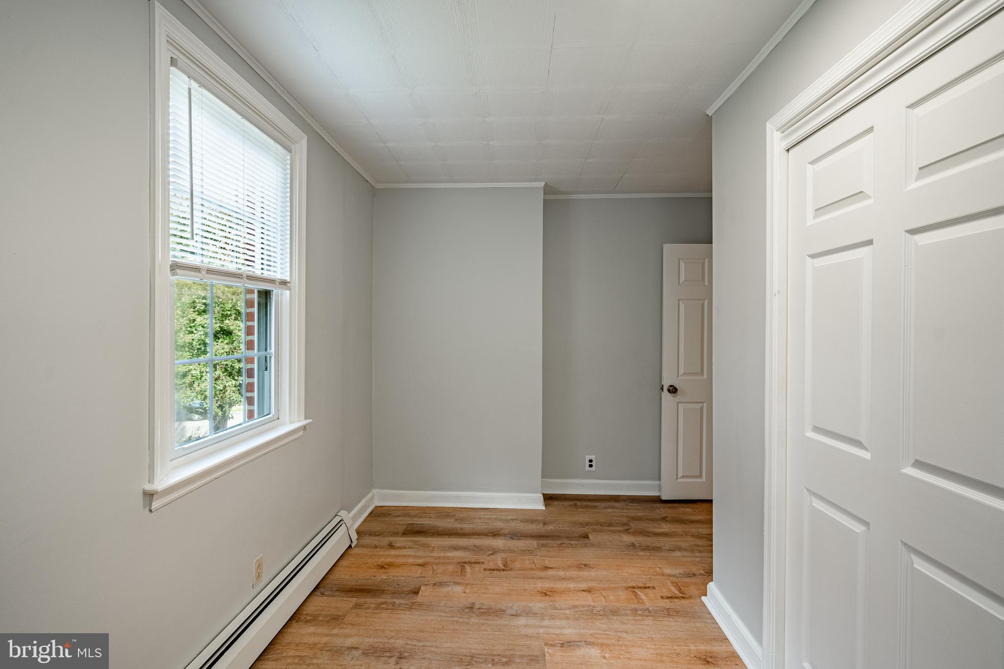 4234 Valley Road, Unit 1 Drexel Hill, PA 19026 - Photo 16 of 19 a view of an empty room with window and wooden floor