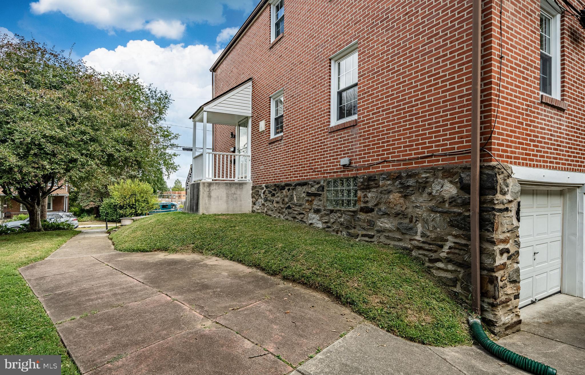 4234 Valley Road, Unit 1 Drexel Hill, PA 19026 - Photo 18 of 19 a brick house with a yard and plants