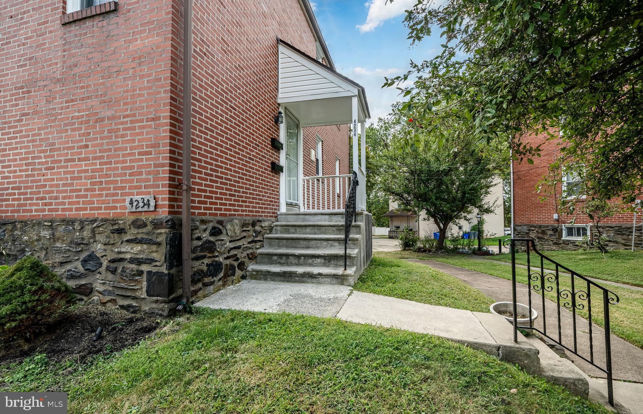 4234 Valley Road, Unit 1 Drexel Hill, PA 19026 - Photo 2 of 19 a view of a house with a yard and a garden