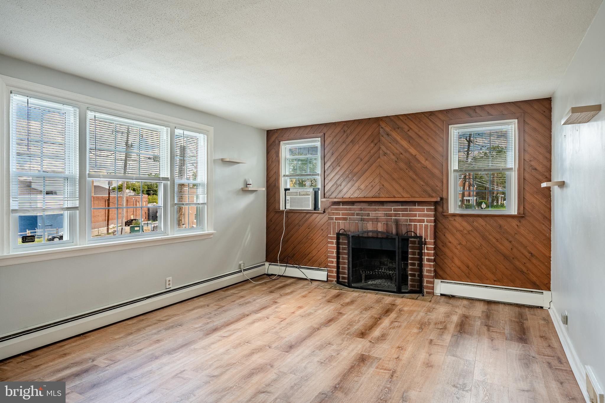 4234 Valley Road, Unit 1 Drexel Hill, PA 19026 - Photo 3 of 19 an empty room with windows and fireplace