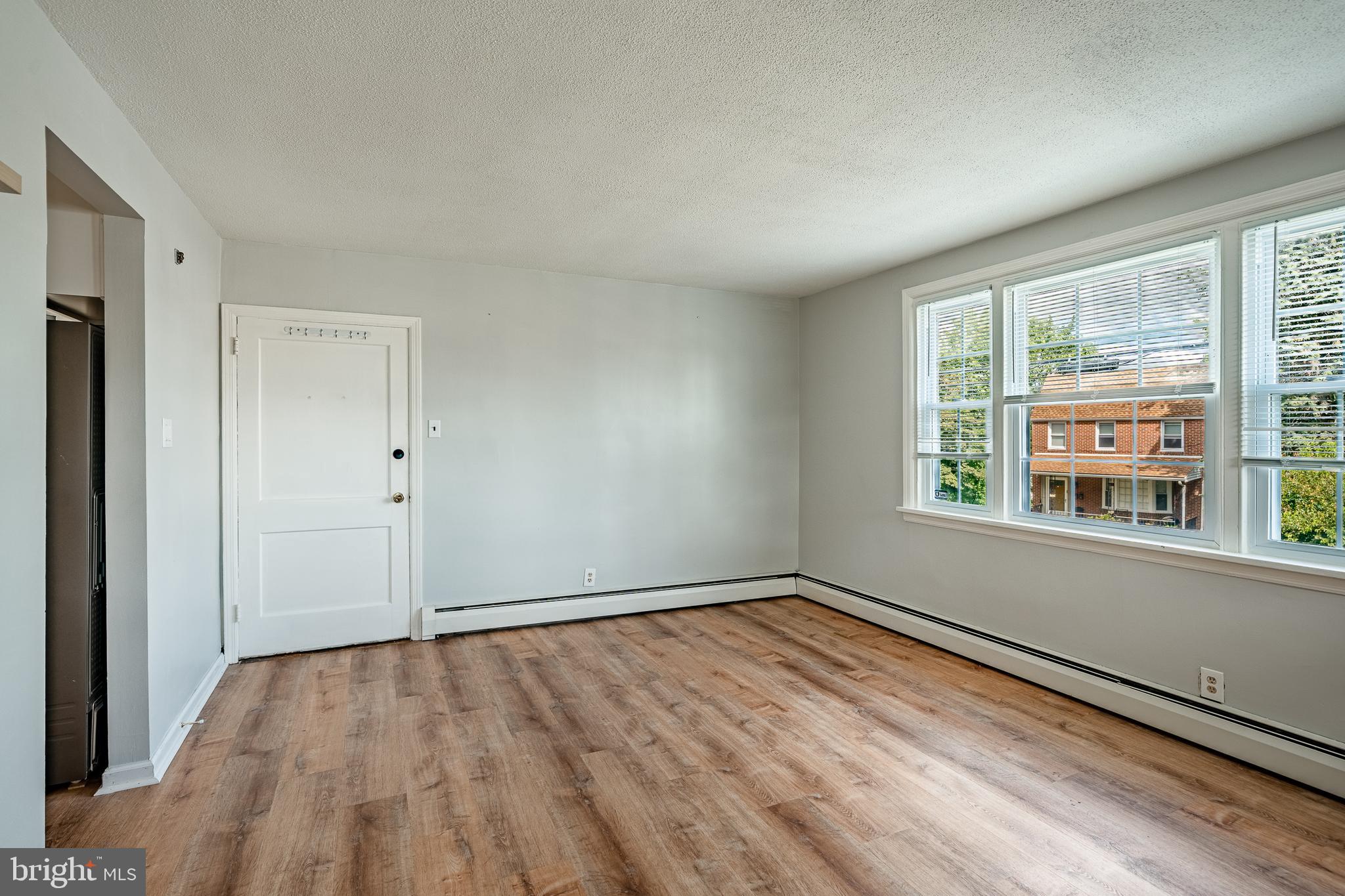 4234 Valley Road, Unit 1 Drexel Hill, PA 19026 - Photo 6 of 19 a view of an empty room with wooden floor and a window