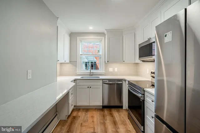 a kitchen with a sink stove and refrigerator