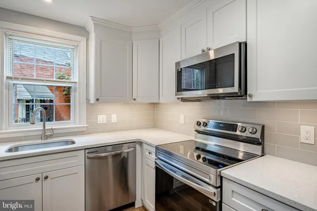 a kitchen with appliances a sink and a stove
