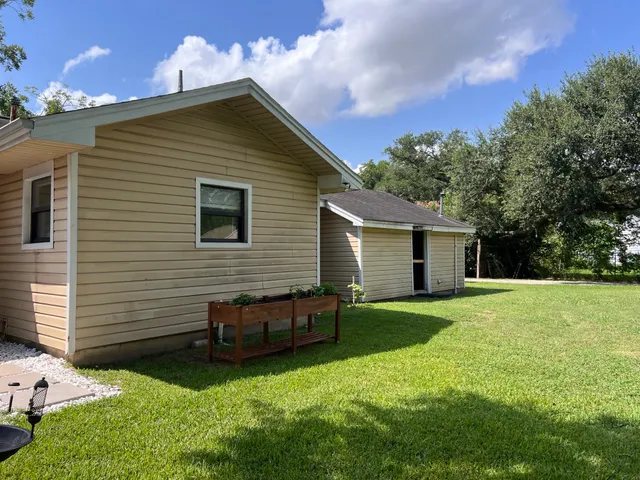 a view of a house with a yard porch and sitting area