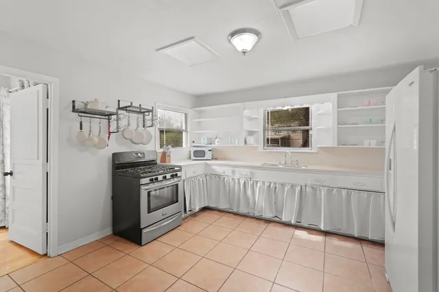 a kitchen with granite countertop cabinets and steel stainless steel appliances