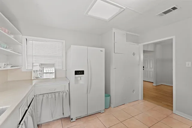 a kitchen with sink cabinets and refrigerator