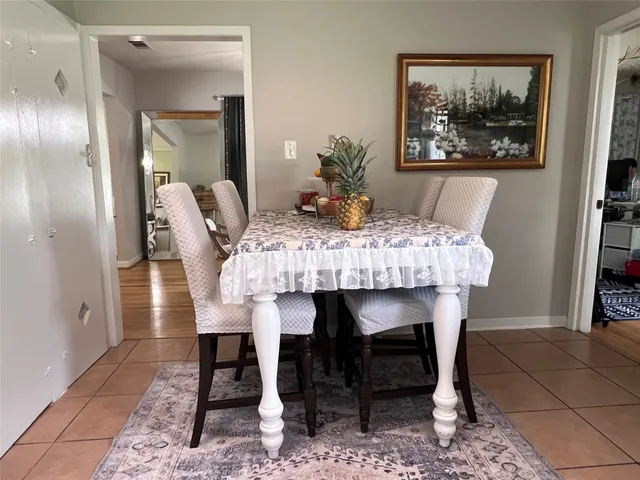 a view of a dining room with furniture a chandelier and wooden floor
