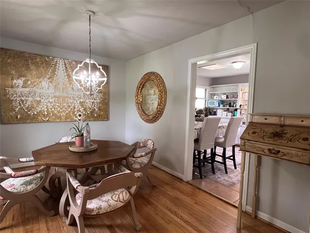 a living room with furniture a window and a clock