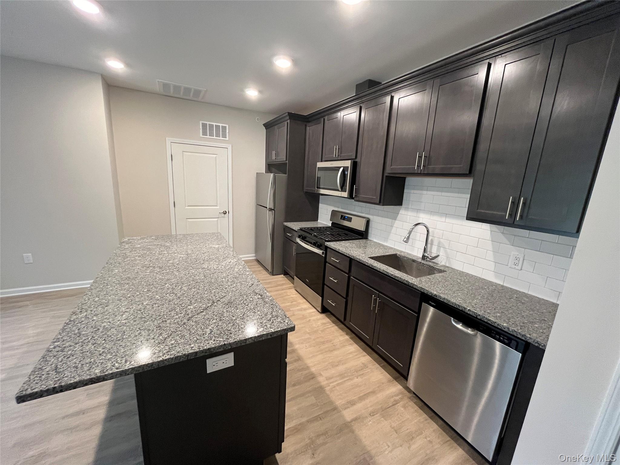 415 Tower Ridge Circle Middletown, NY 10941 - Photo 3 of 5 a large kitchen with stainless steel appliances granite countertop a sink stove and refrigerator
