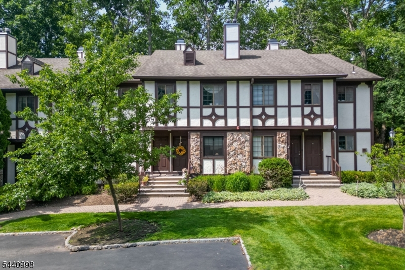 609 Mark Twain Way Mahwah, NJ 07430 - Photo 28 of 40 a front view of a house with a yard and potted plants