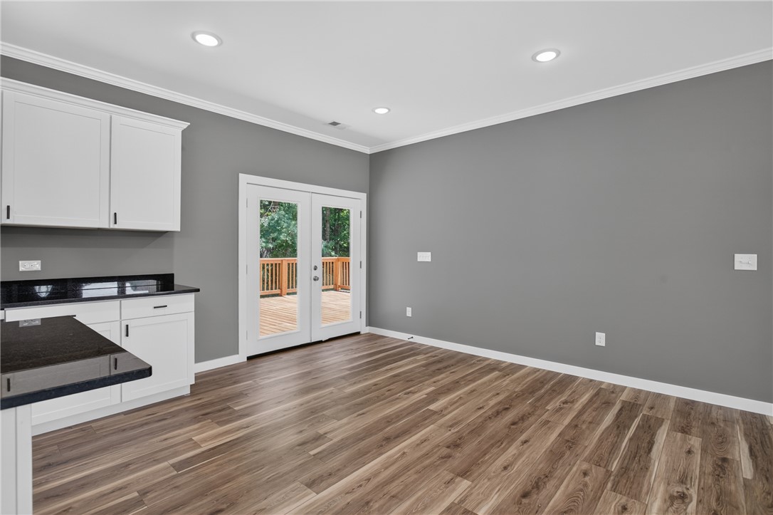 223 Maple Drive Anderson, SC 29621 - Photo 13 of 45 A streamlined kitchen area with ample counter space and French doors leading to an outdoor deck.