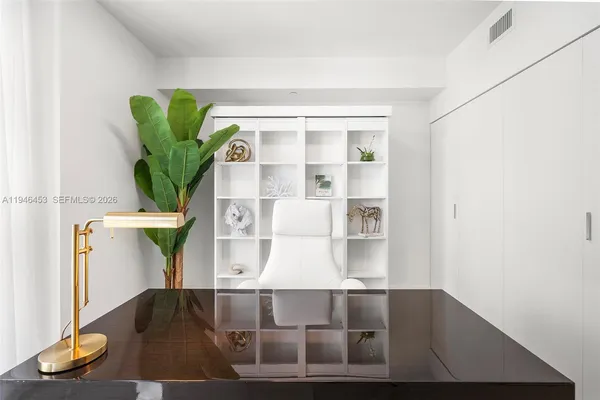 a bedroom with furniture and a large window