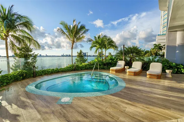 a swimming pool with outdoor seating and plants