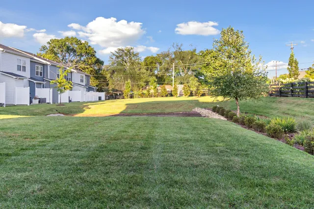 a view of a house with chairs and table in a patio