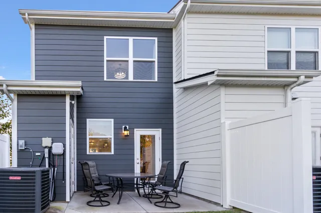 a view of a patio with table and chairs with wooden floor and plants