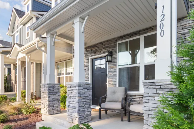 a front view of a house with outdoor seating