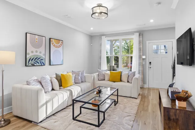 a living room with furniture and wooden floor