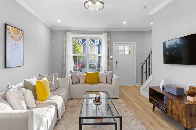 a living room with furniture and a flat screen tv