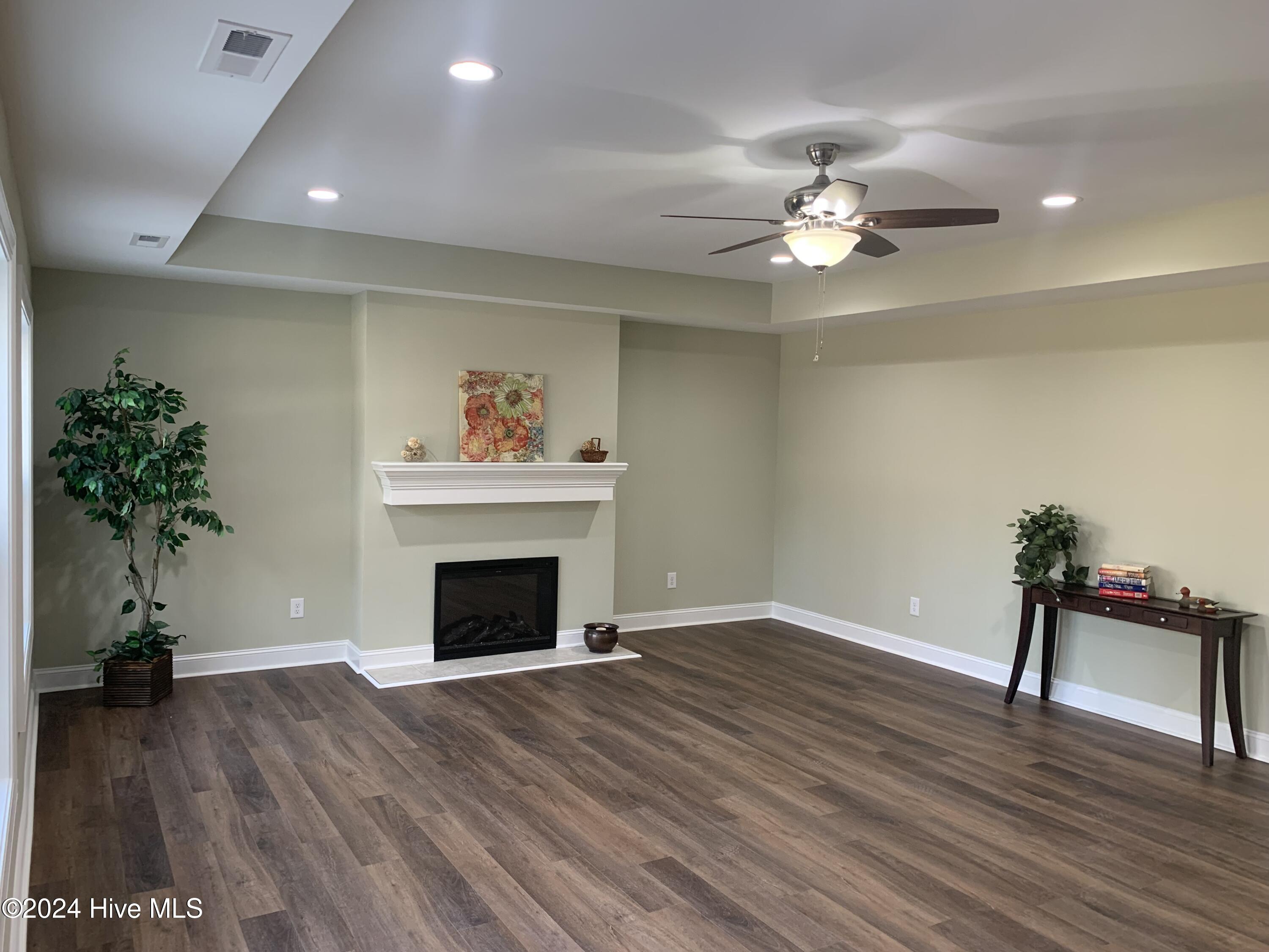 2503 Wild Turkey Road New Bern, NC 28562 - Photo 16 of 23 Trey ceiling in family room, kitchen and dining area