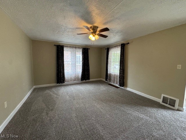 520 8th Street Struthers, OH 44471 - Photo 7 of 22 Spare room featuring ceiling fan, carpet flooring, and a textured ceiling