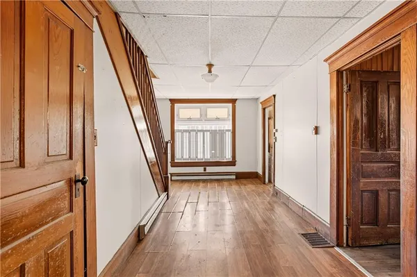 a view of an entryway with wooden floor