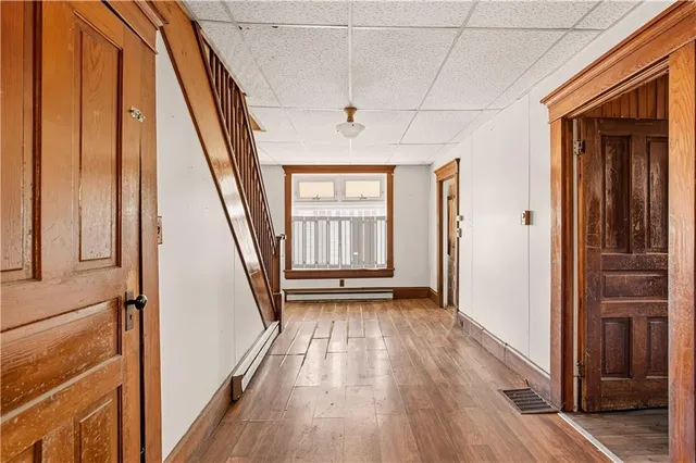 a view of an entryway with wooden floor