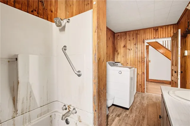 a bathroom with a granite countertop sink a mirror and shower