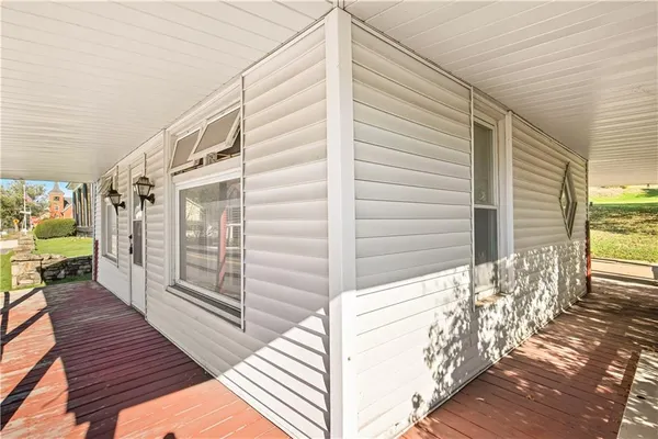 a view of a balcony with wooden floor