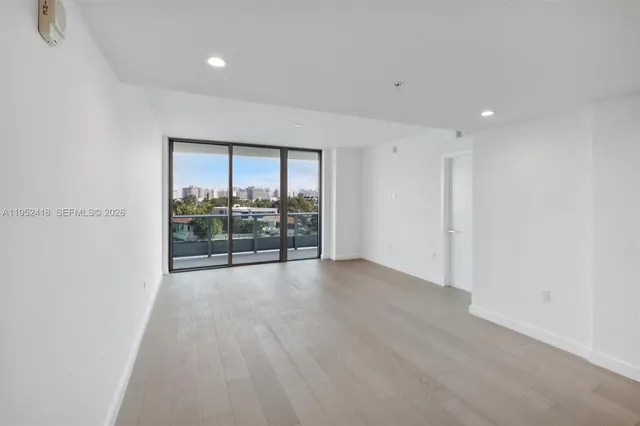a view of kitchen and refrigerator