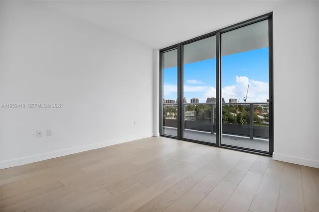 a kitchen with kitchen island a sink a stove and cabinets