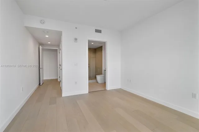 a spacious bathroom with a double vanity sink a mirror and a bathtub