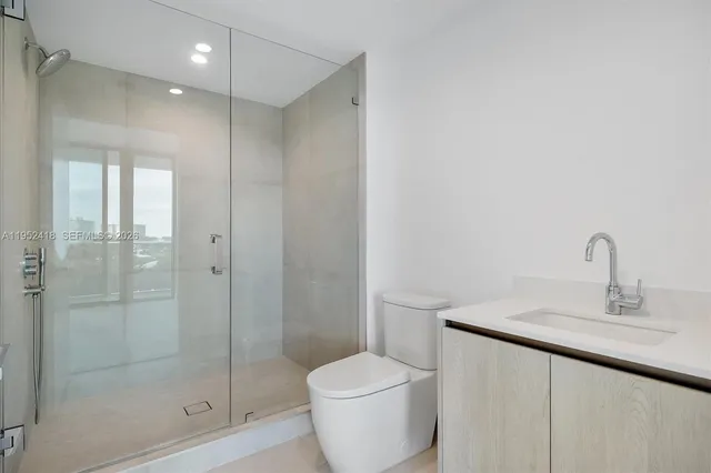 a bathroom with a sink double vanity and a shower