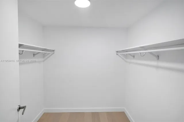 a view of an empty room with sliding glass door