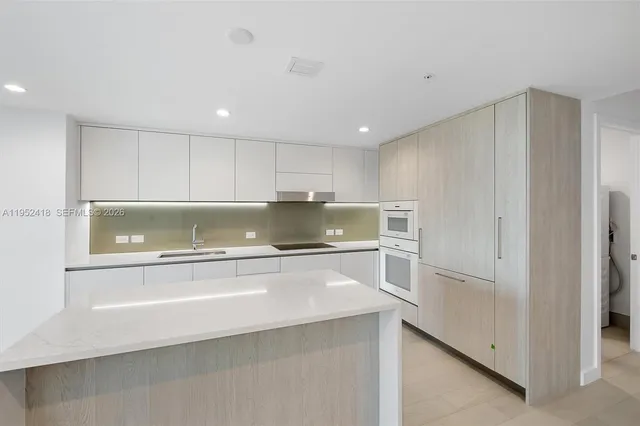 a view of a porch with chairs and potted plants