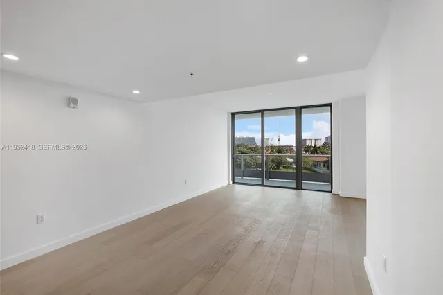 an empty room with sliding glass door and glass door