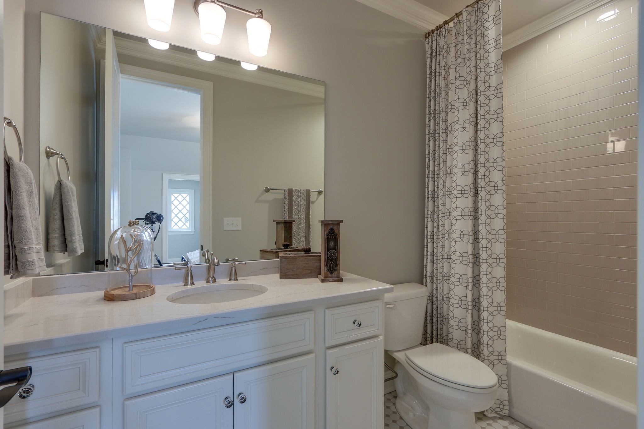 513 Rowan Street Franklin, TN 37064 - Photo 32 of 36 a bathroom with a sink a toilet a mirror a vanity and shower