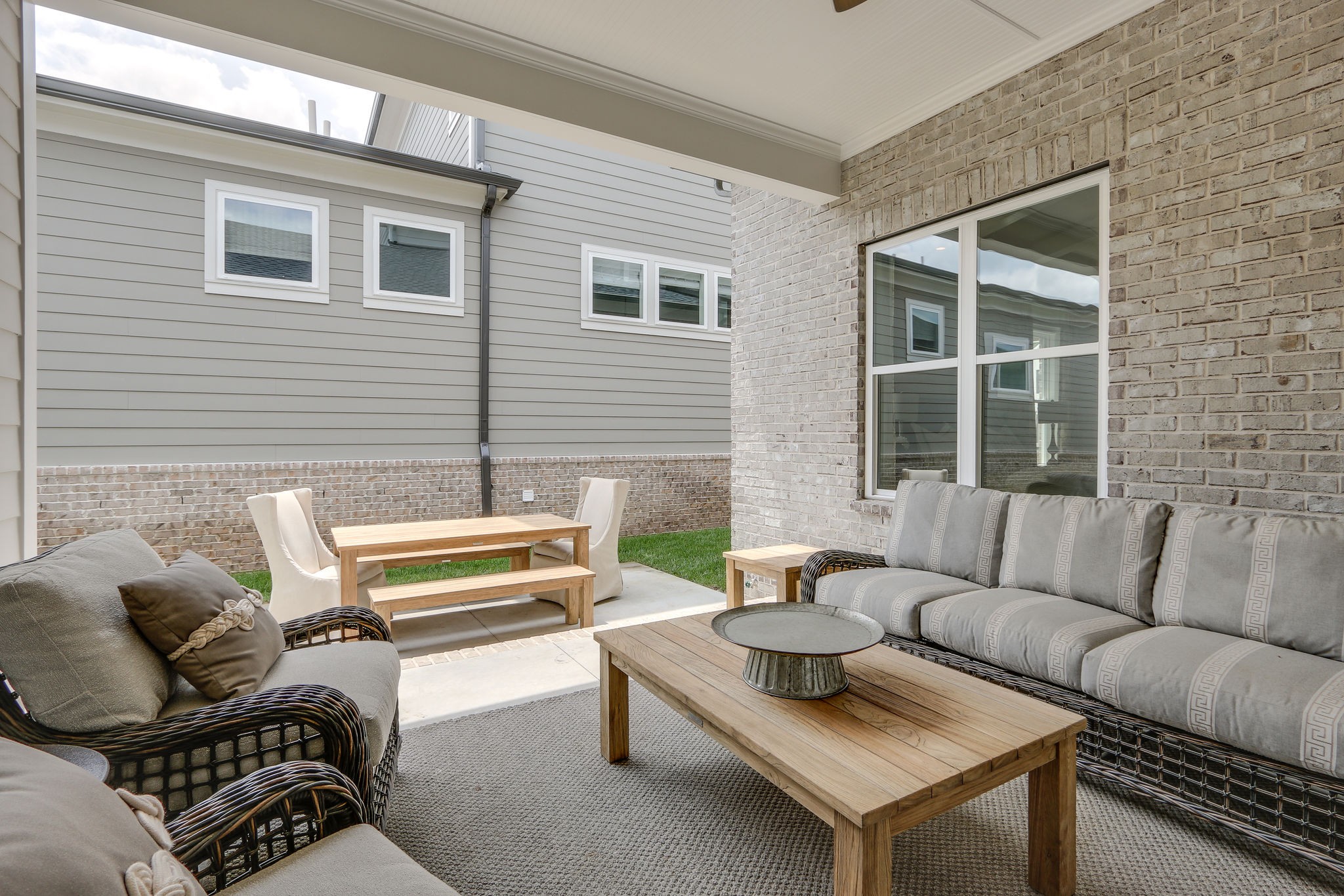 513 Rowan Street Franklin, TN 37064 - Photo 34 of 36 a view of a patio with couches and a dining table with wooden floor