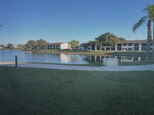 a view of house with outdoor space and lake view