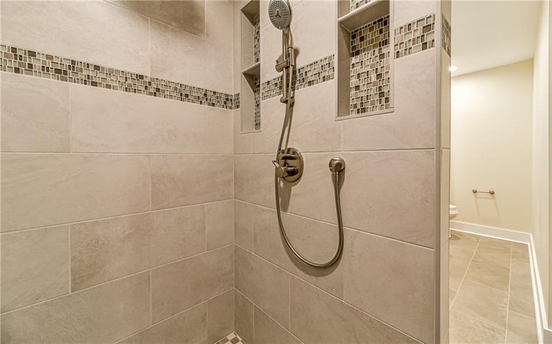 309 Parkhill Road Baden, PA 15005 - Photo 14 of 25 Step right into this over sized ceramic tile shower with rain head and hand held faucet.