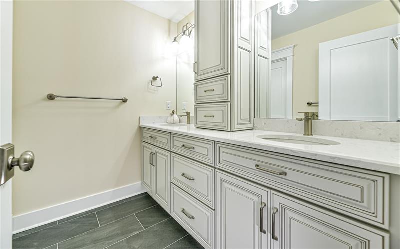309 Parkhill Road Baden, PA 15005 - Photo 21 of 25 The second level bathroom boasts Shiloh soft close custom cabinetry, linen tower, double bowl sink with quartz counter top, ceramic tile flooring with separate commode and bathtub.