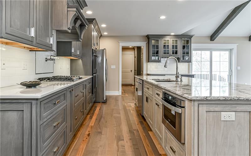 309 Parkhill Road Baden, PA 15005 - Photo 4 of 25 Shiloh custom cabinetry with soft close drawers and doors, pull out shelving, spice shelf and luxurious quartz counter tops. Twelve foot center island with dishwasher and microwave drawer.