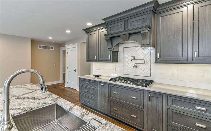 309 Parkhill Road Baden, PA 15005 - Photo 5 of 25 Subway tile back splash and five burner gas cook top with pot filler and range hood accompany this Gourmet kitchen.