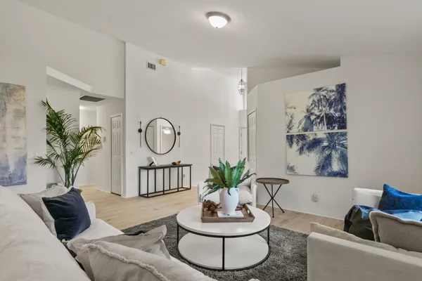 a dining room with furniture and a floor to ceiling window
