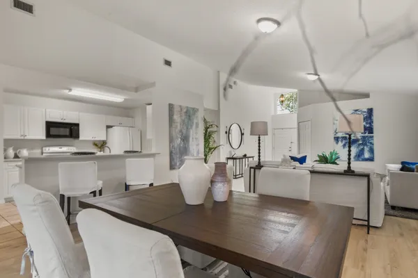 a kitchen with cabinets appliances a sink and a window