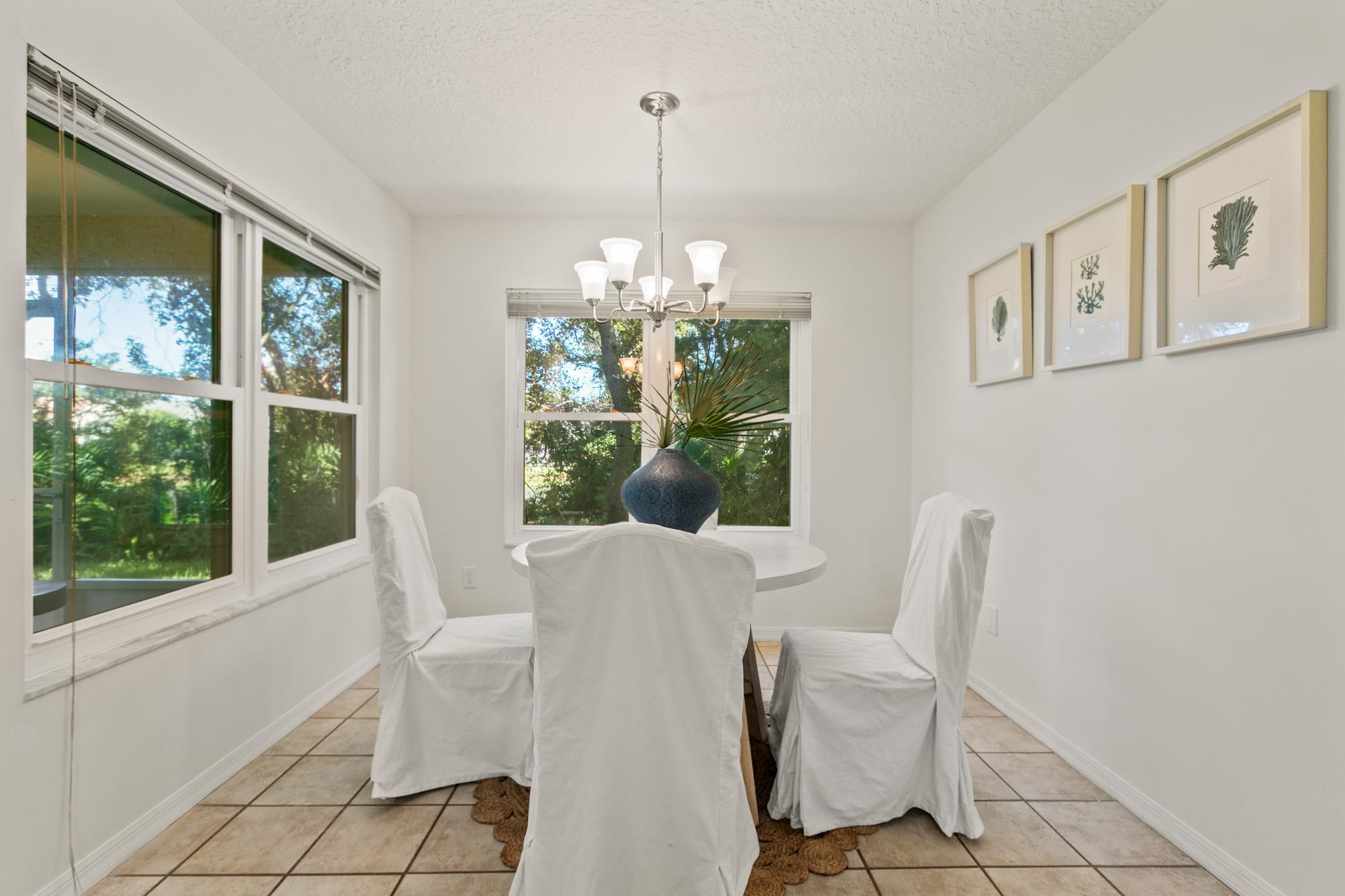 541 Peninsula Court St. Augustine, FL 32080 - Photo 31 of 63 a dining room with furniture a chandelier and window