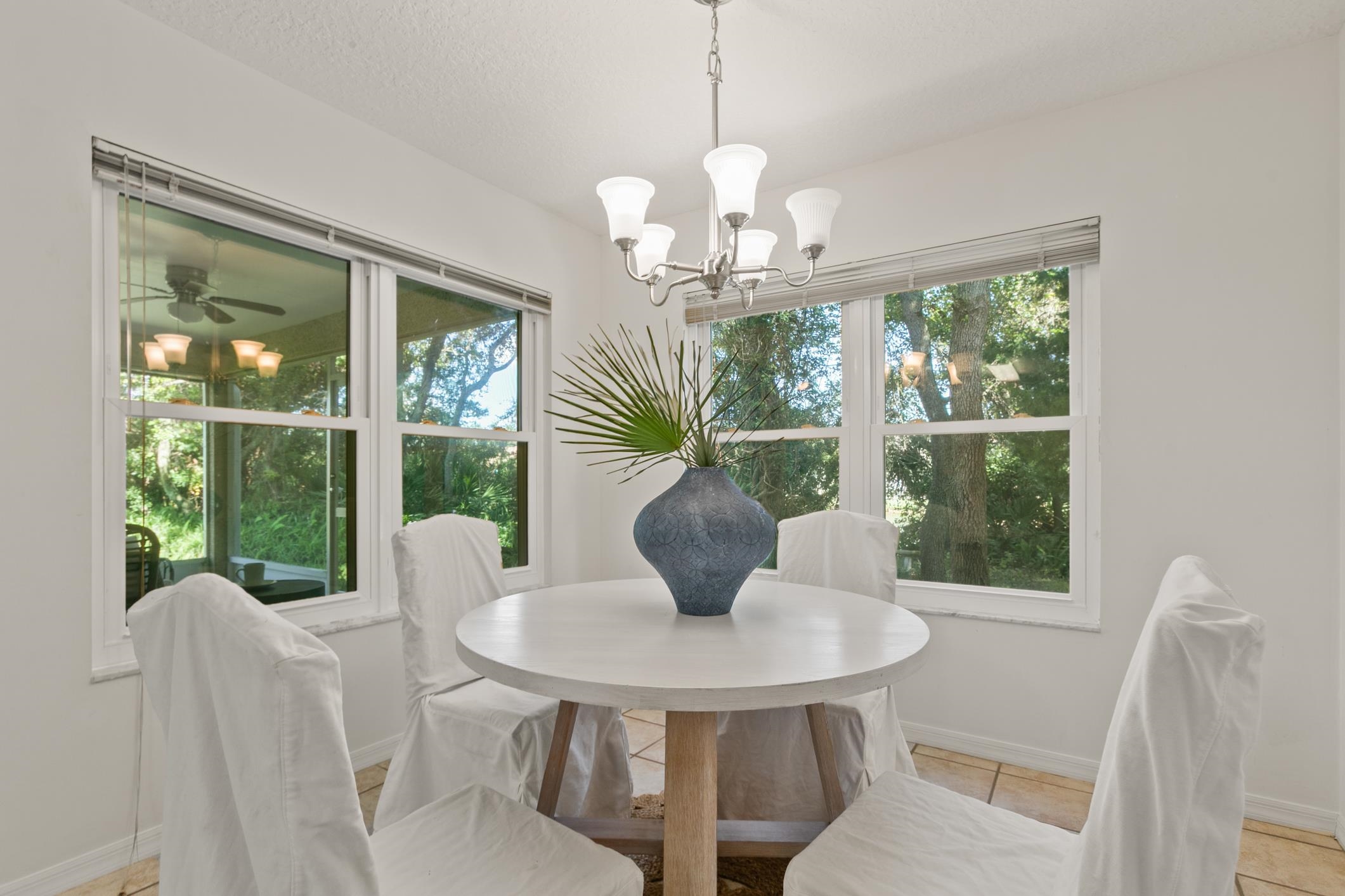 541 Peninsula Court St. Augustine, FL 32080 - Photo 34 of 63 a view of a dining room with furniture a chandelier and window