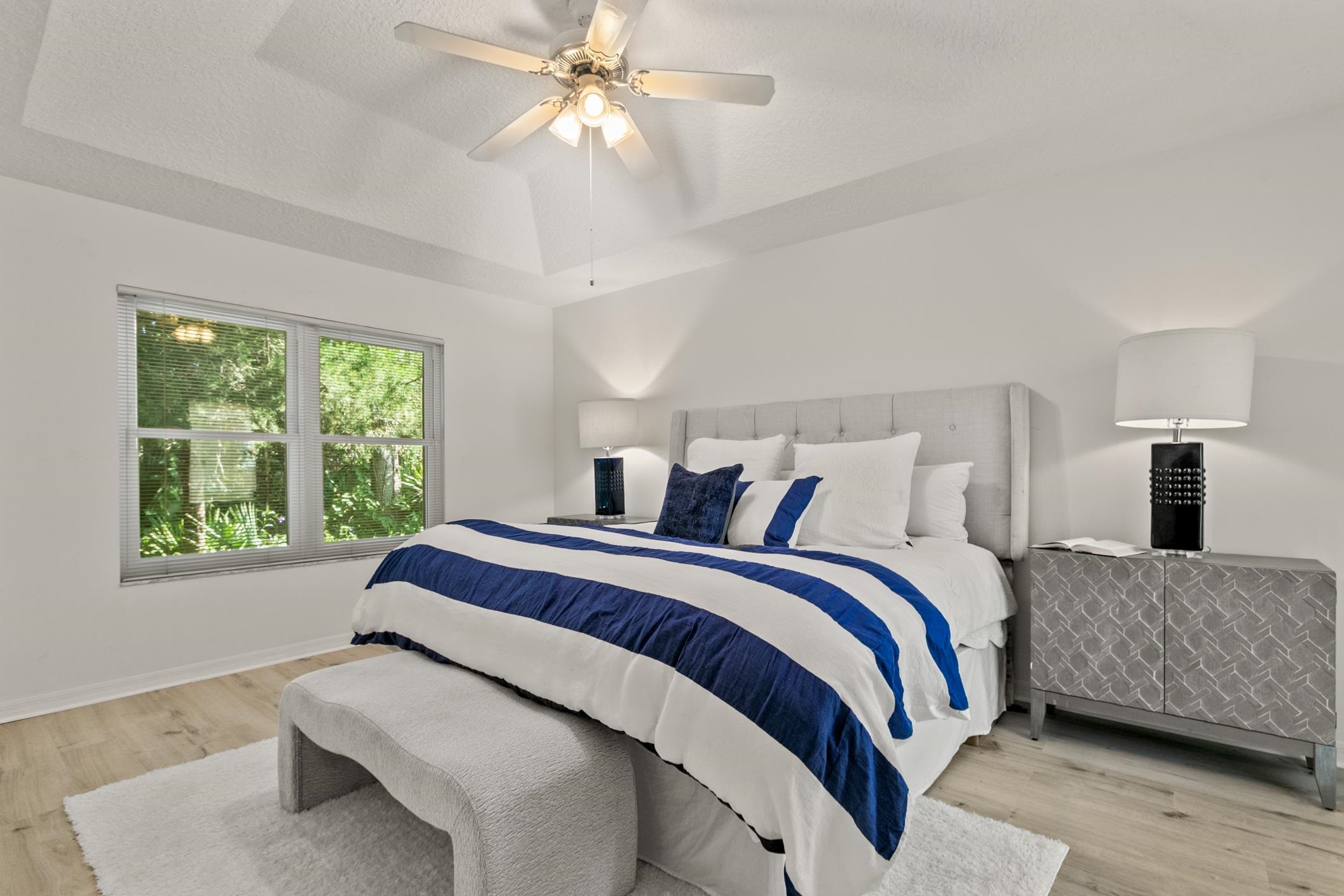 541 Peninsula Court St. Augustine, FL 32080 - Photo 35 of 63 a spacious bedroom with a large bed and a chandelier