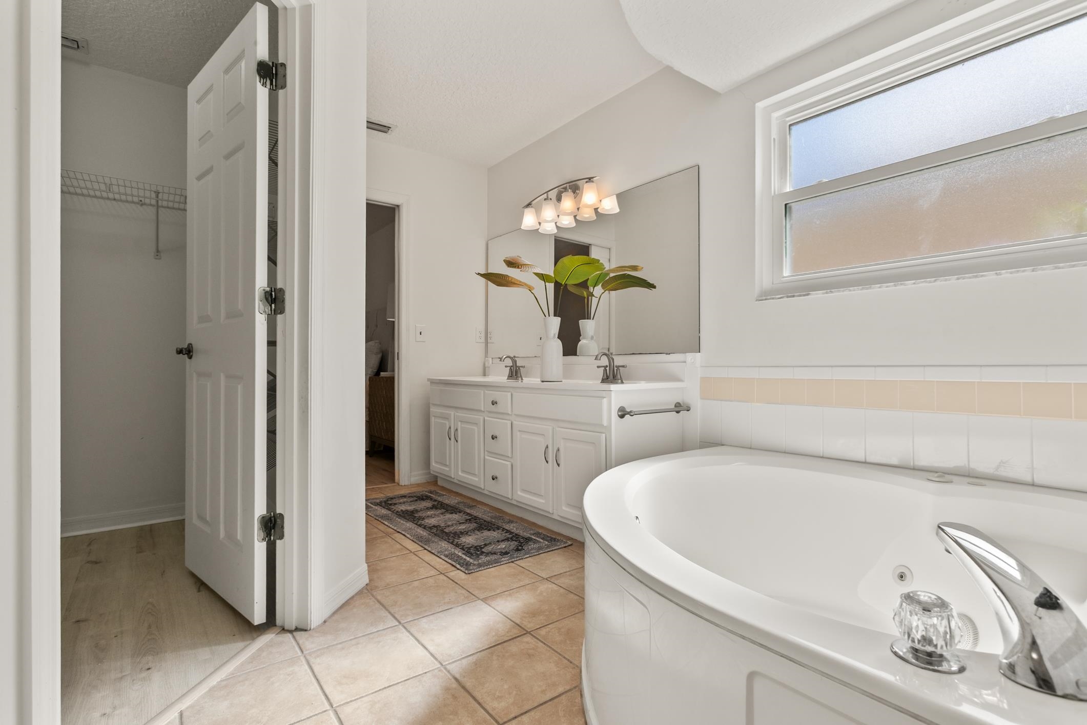 541 Peninsula Court St. Augustine, FL 32080 - Photo 44 of 63 a bathroom with a tub sink and mirror