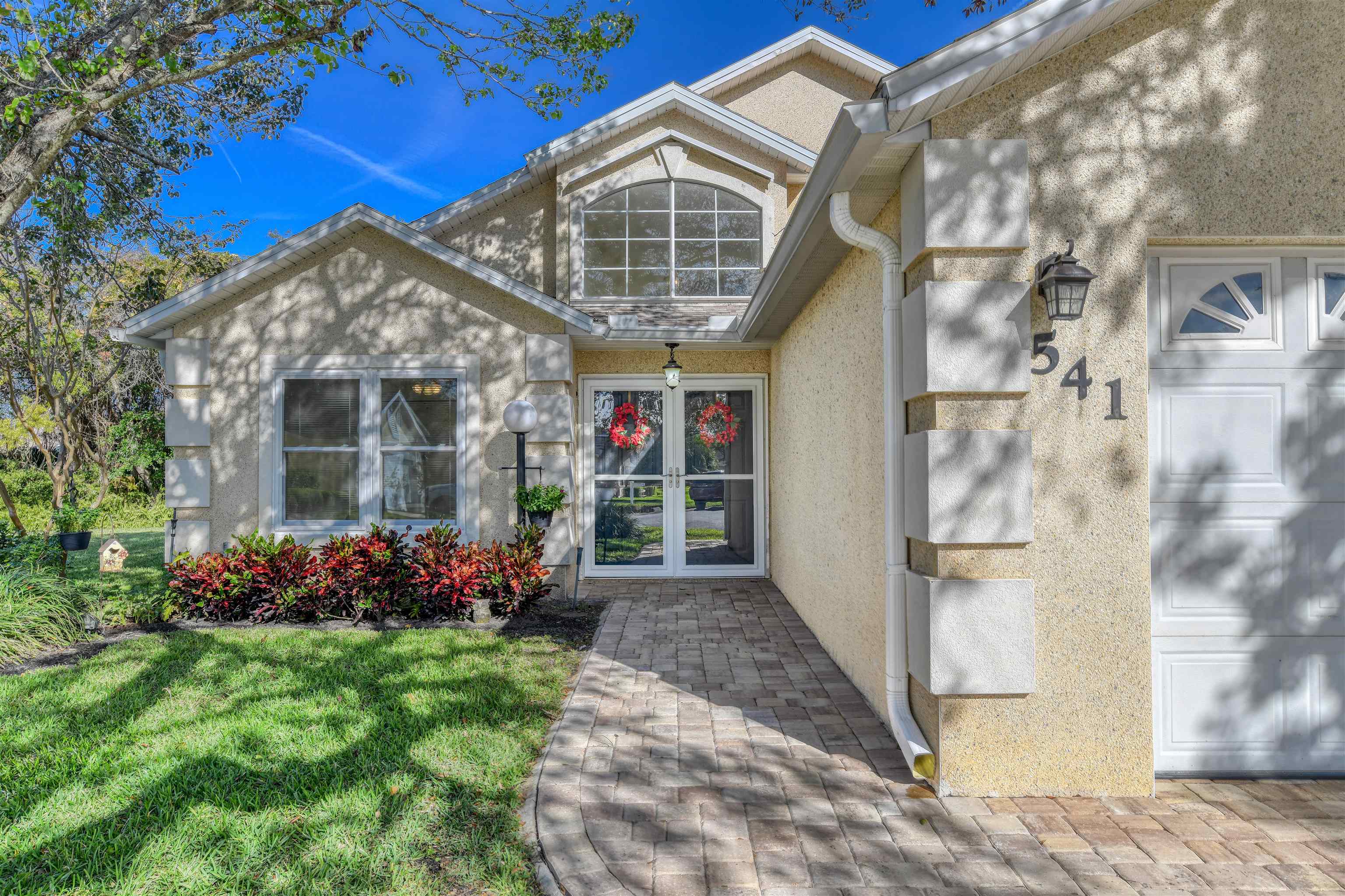 541 Peninsula Court St. Augustine, FL 32080 - Photo 5 of 63 a front view of a house with garden